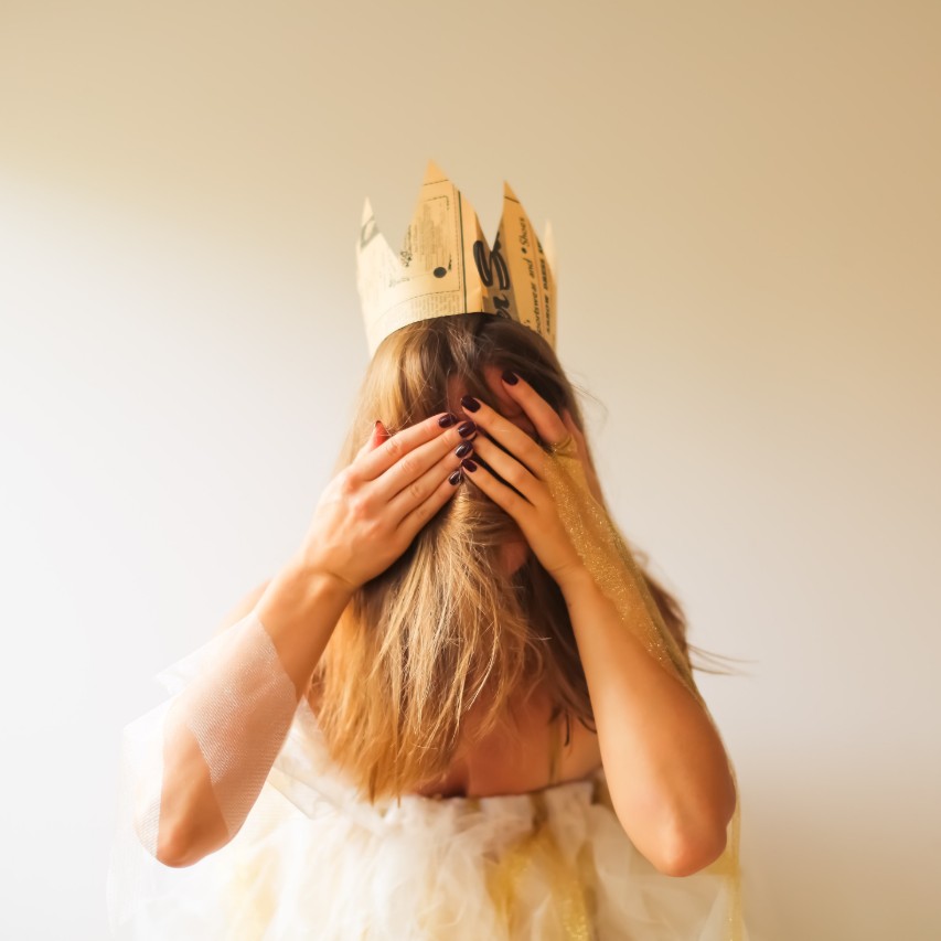 young woman covering her face with her hands