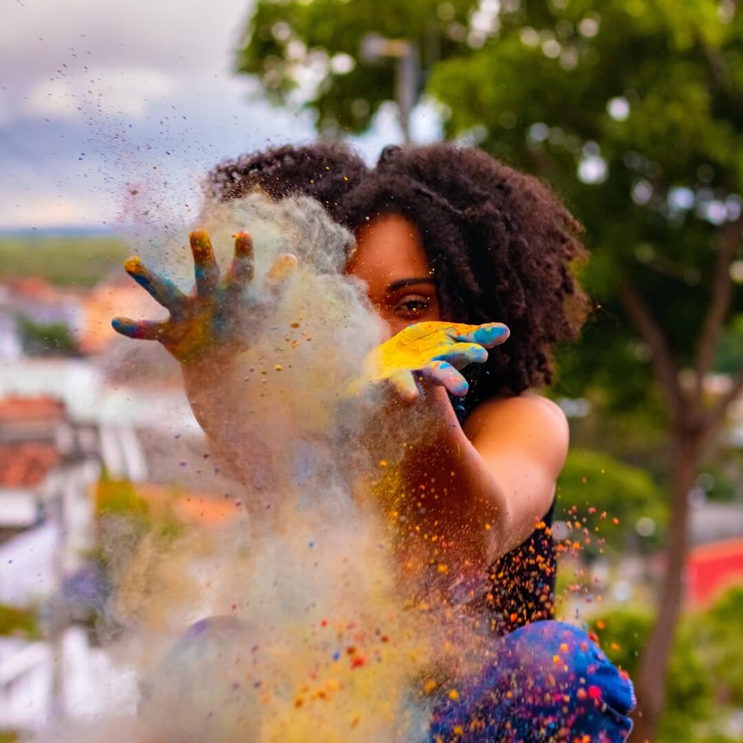 young girl playing with paint dust manifesting her dreams