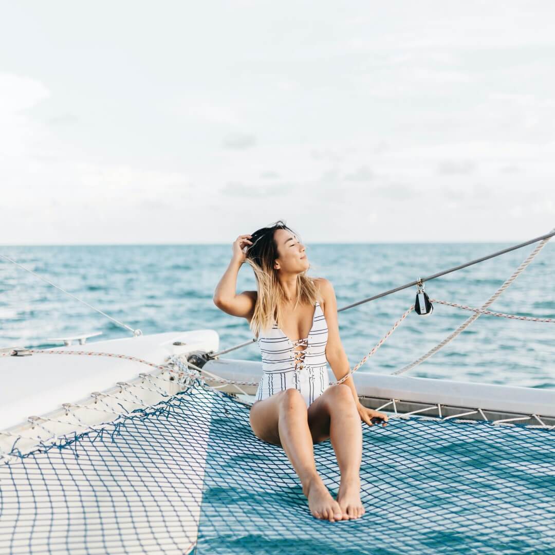 woman smiling on a boat in pursuit of a perfect life